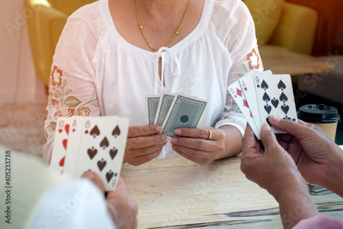 Retired people playing card in a retirement home. photo