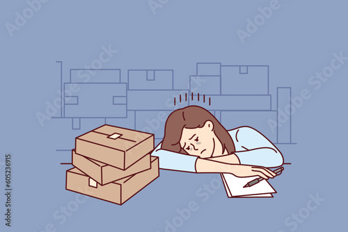 Upset girl near cardboard boxes works in warehouse or logistics company and falls asleep sitting at table. Tired woman feels lack of motivation to work in warehouse or fulfillment industry