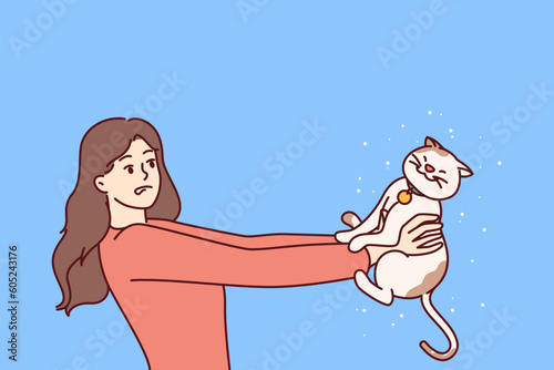 Woman is allergic to kitten and flying fur from pet and needs to take allergen suppressant pill or consult allergist doctor. Girl suffering from allergic reaction to cats looks at cute pet with fear