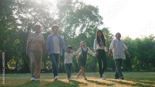 Happy Asian family walking in the public park, Outdoor with big family and summer season concept
