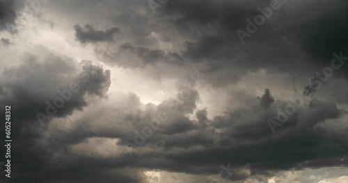 Gloomy rain clouds fly across the sky, sunlight breaks through. Time lapse looped video