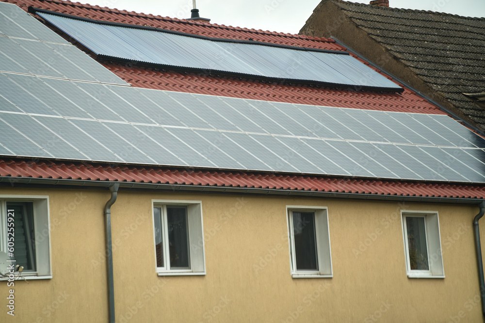 Water solar collector on a red metal roof. Solar thermal and solar panel for hot water.