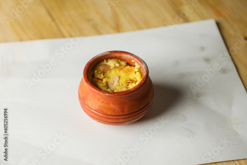 Firni, phirni anf kheer with nuts served in pot isolated on mat top view of indian, bangali and pakistani dessert mithai photo