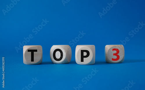 Top 3 symbol. Concept word Top 3 on wooden cubes. Beautiful blue background. Business and Top 3 concept. Copy space.