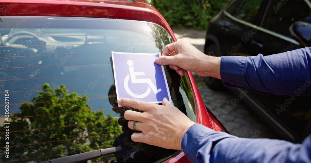 Driver Putting Wheelchair Sticker Sign