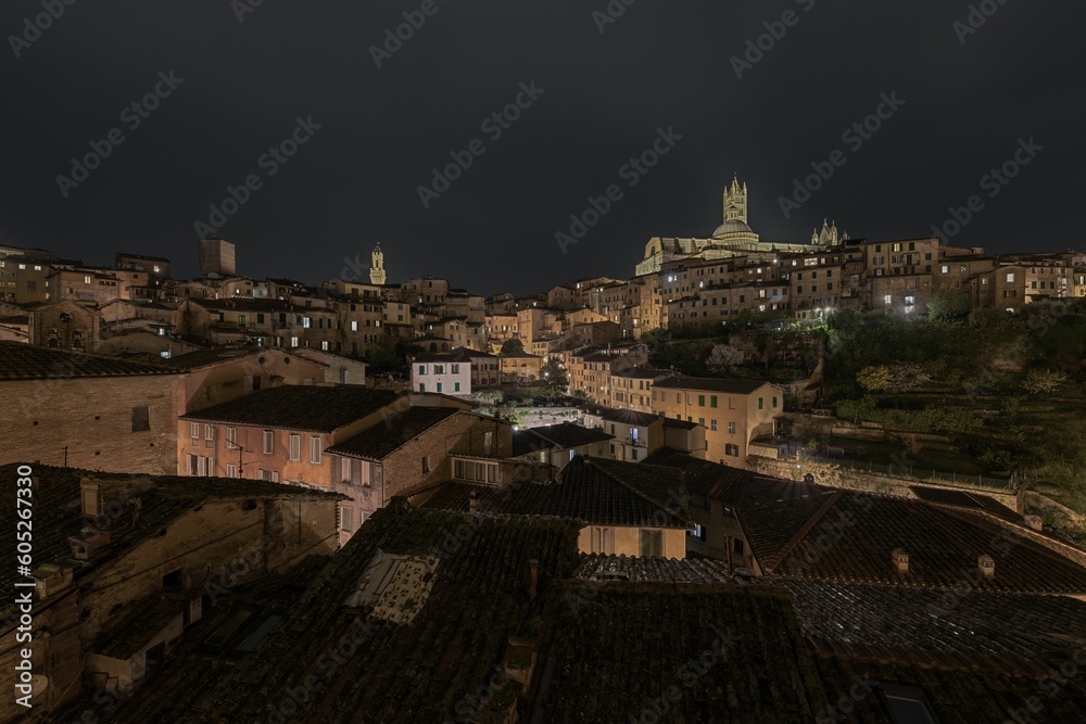 A beautiful shot of the historic cityscape of Siena, Italy at night