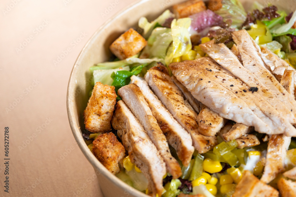 Grilled chicken breast, fillet and fresh vegetable salad of lettuce, arugula, spinach, cucumber and tomato. Healthy lunch menu. Diet food. Top view Grilled chicken breast, fillet and fresh vegetable salad of lettuce, arugula, spinach, cucumber and tomato. Healthy lunch menu. Diet food. Top view