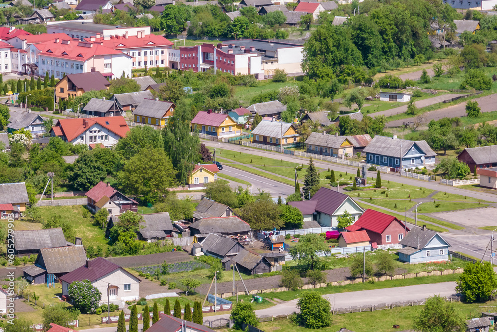 panoramic aerial view of a small urban-type settlement with red roofs