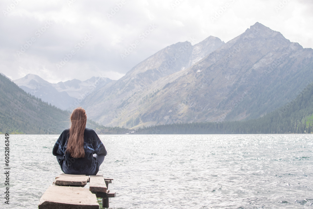Dreaming woman enjoys the view of the Multinsky lake. Empty space for text Dreaming woman enjoys the view of the Multinsky lake. Empty space for text