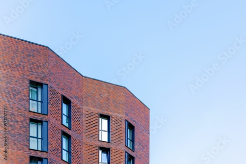 Beautiful facade of a modern building against a blue sky during daytime