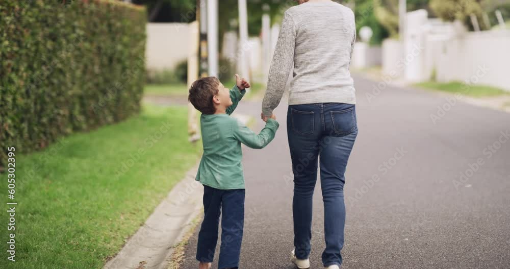 Back, children and a boy walking with his grandmother on a street in their neighborhood together. Kids, family or bonding and a senior woman holding hands with her grandson on a residential road Back, children and a boy walking with his grandmother on a street in their neighborhood together. Kids, family or bonding and a senior woman holding hands with her grandson on a residential road