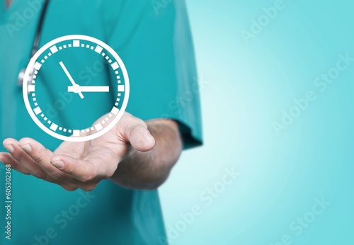 Doctor in a uniform holding service icon of clock