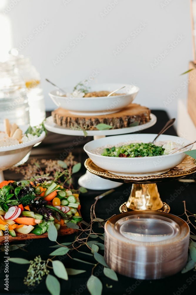 Holiday table with salads and dishes on a black tablecloth Holiday table with salads and dishes on a black tablecloth