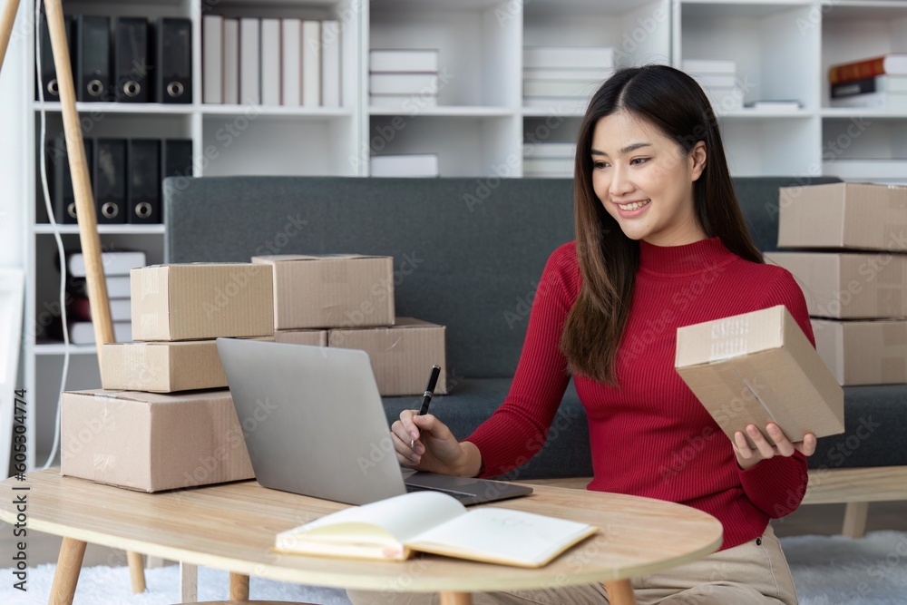 SME online business ideas small business startup a asian female entrepreneur uses a laptop computer to check online orders and prepare packages for customers SME online business ideas small business startup a asian female entrepreneur uses a laptop computer to check online orders and prepare packages for customers