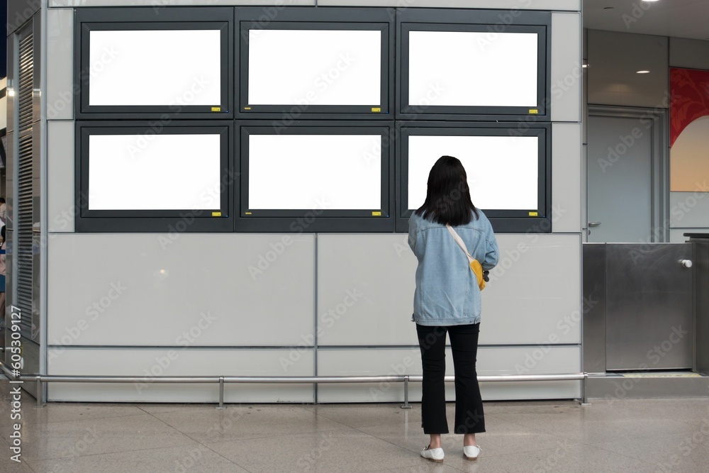 Woman looking at white screens on a wall Woman looking at white screens on a wall