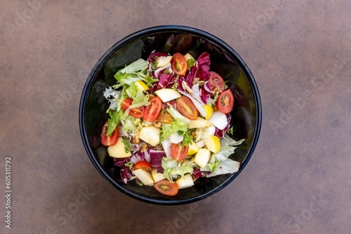 Top view of a fresh vegetable salad in a bowl served in a restaurant