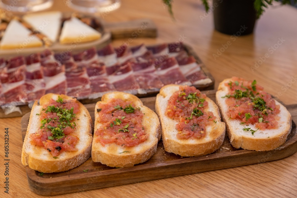 Closeup of bread slices with meat on a wooden tray