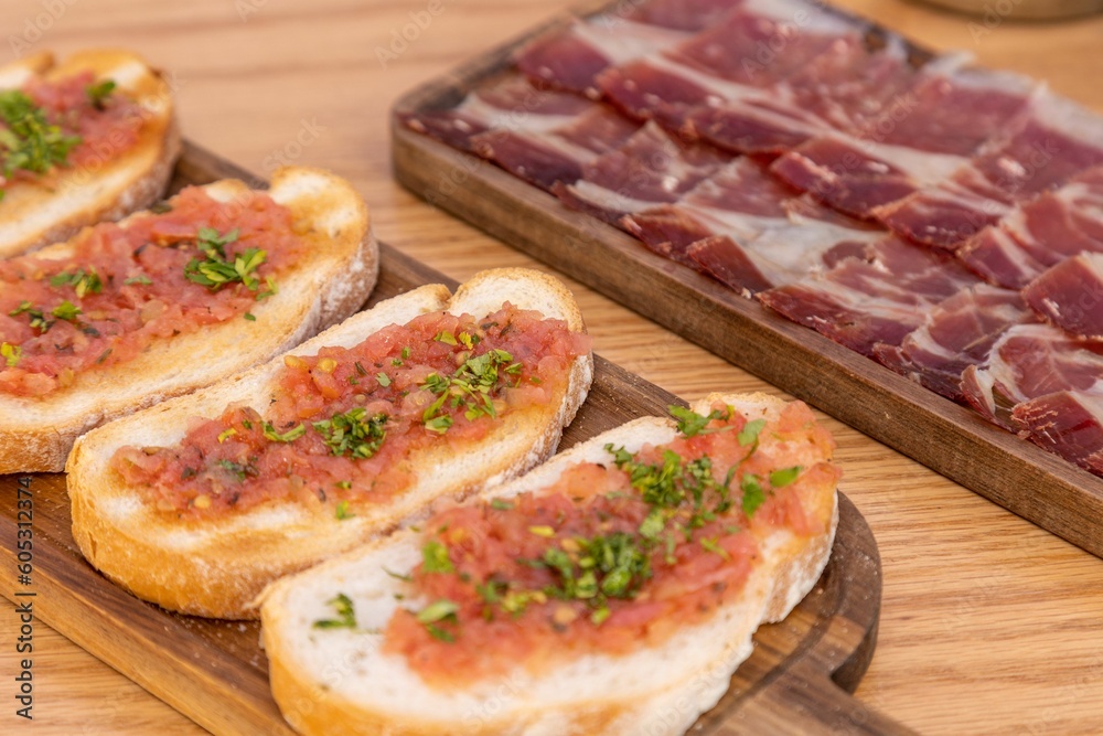 Closeup of bread slices with meat on a wooden tray Closeup of bread slices with meat on a wooden tray