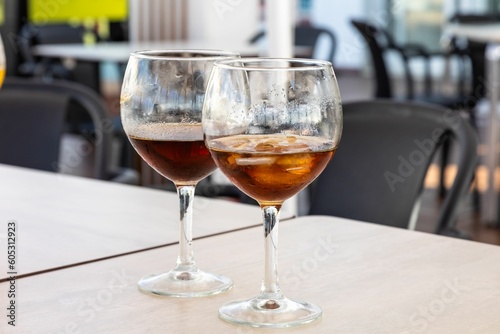 Closeup of two glasses of dark brown drinks on the table