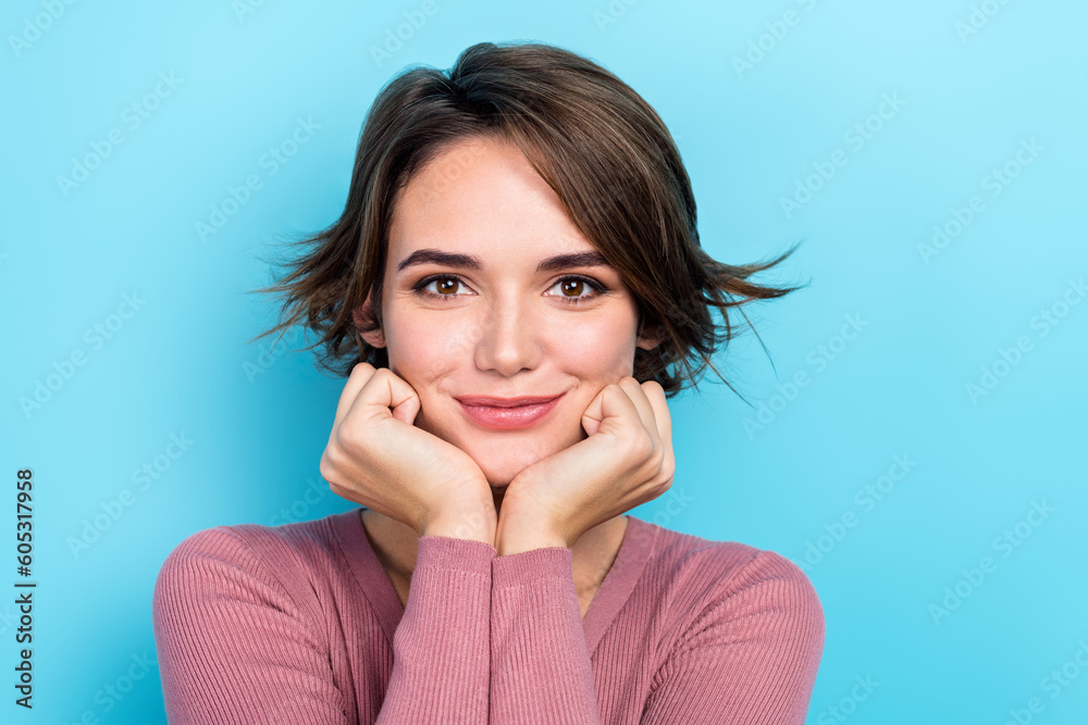 Portrait of adorable positive lady hands touch cheeks empty space ad isolated on blue color background Portrait of adorable positive lady hands touch cheeks empty space ad isolated on blue color background