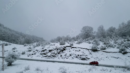 Winter Wonderland: Snowy Road at Vigla Mountain, Near Florina, Greece - Red Car Passing (ID: 605318109)