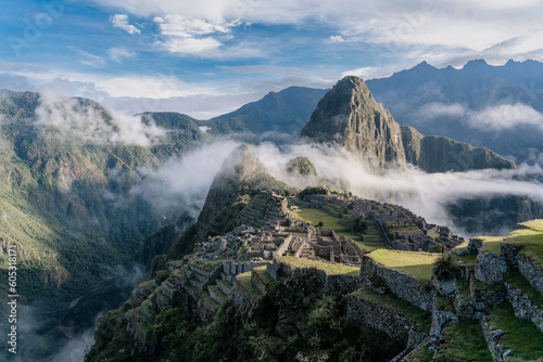 machu picchu in the morning with clounds and fog photo