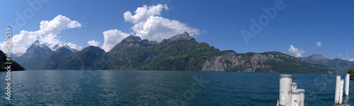 Wide angle mountain panorama with Lake Uri in the foreground on a sunny spring day. Photo taken May 22nd, 2023, Sisikon, Switzerland. © Michael Derrer Fuchs