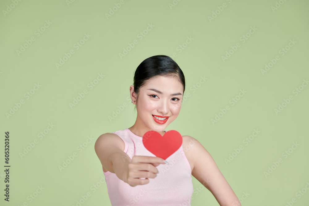 pretty Asian woman with toothy smile while holding Valentines Day card in hands, pretty Asian woman with toothy smile while holding Valentines Day card in hands,