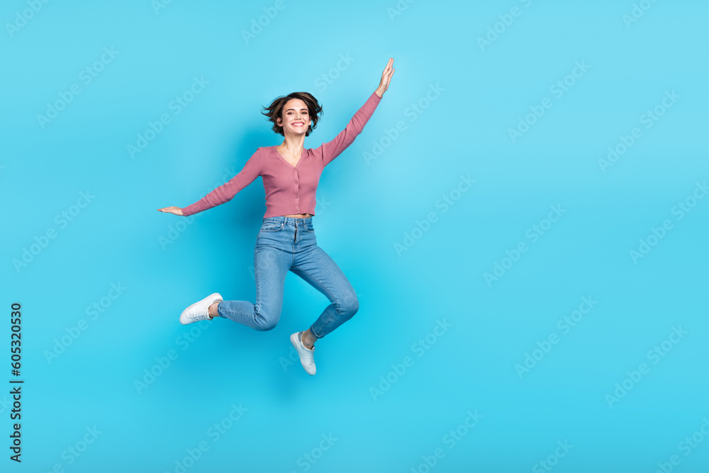 Full size portrait of overjoyed pretty girl jumping have good mood empty space isolated on blue color background