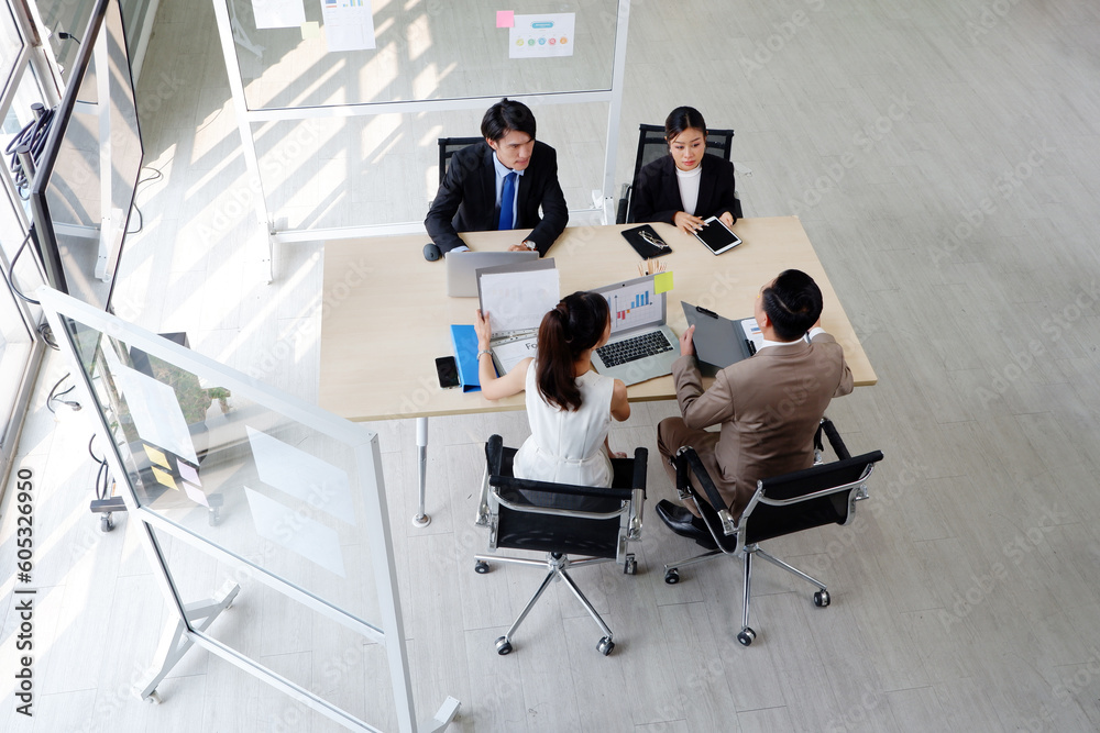 © krongthip - Team of smiling business people sitting at the table and marketing planning meeting. © krongthip - Team of smiling business people sitting at the table and marketing planning meeting.