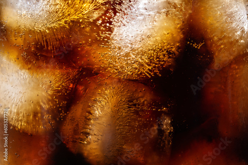 Cola and ice cubes macro texture. Cola drink with ice closeup background.