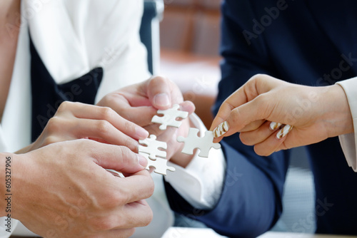 businessman hand holding jigsaw puzzle.