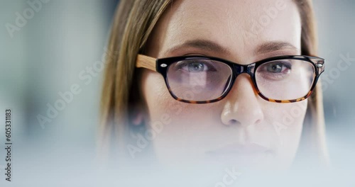 Computer, office and face of woman focus on company analytics, online analysis or research project. Eyes, reading and professional person concentrate on problem solving, business work or statistics