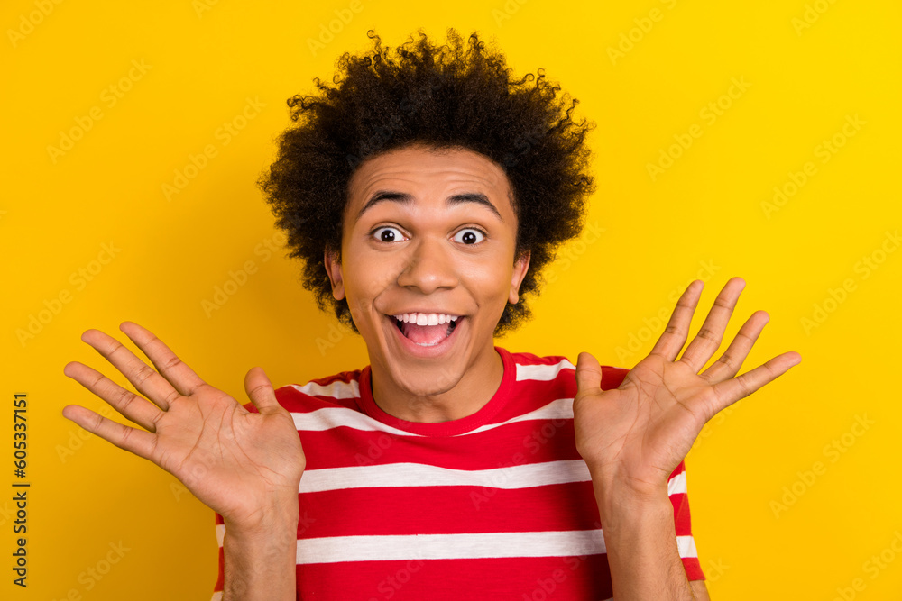 Photo of impressed funky man dressed red t-shirt smiling rising hands arms isolated yellow color background Photo of impressed funky man dressed red t-shirt smiling rising hands arms isolated yellow color background