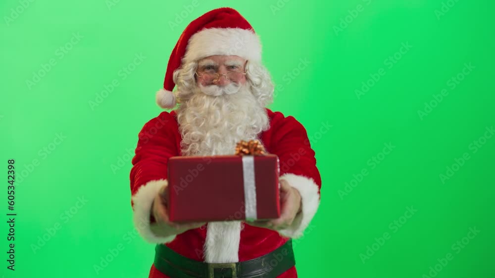 Studio Shot Isolated Mockup Template: Jolly Santa Claus Offering Gift In Red Wrapping Paper To Children On Green Screen Chromakey Background. Concept Of Christmas, Holidays, New Year, Celebration. Studio Shot Isolated Mockup Template: Jolly Santa Claus Offering Gift In Red Wrapping Paper To Children On Green Screen Chromakey Background. Concept Of Christmas, Holidays, New Year, Celebration.