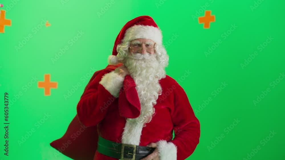 Studio Shot Isolated Mockup Template: Jolly Santa Claus Standing On Green Screen Chromakey Background And Holding Bag With Gifts, Winks The Camera. Christmas, New Year, Holiday Celebration. Zoom Out. Studio Shot Isolated Mockup Template: Jolly Santa Claus Standing On Green Screen Chromakey Background And Holding Bag With Gifts, Winks The Camera. Christmas, New Year, Holiday Celebration. Zoom Out.
