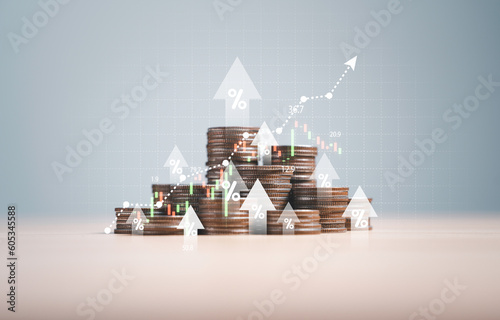Heap of coins money with up arrow and stock market chart for financial banking increase interest rate or mortgage investment dividend from business growth concept.