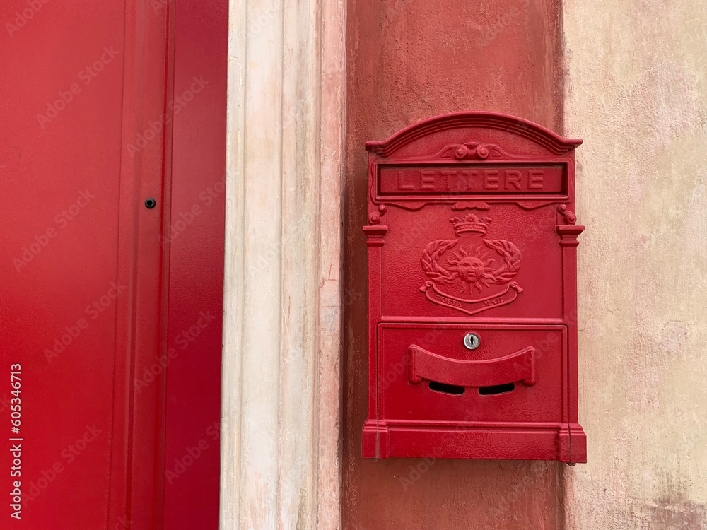European style red mailbox stuck on a cement wall European style red mailbox stuck on a cement wall