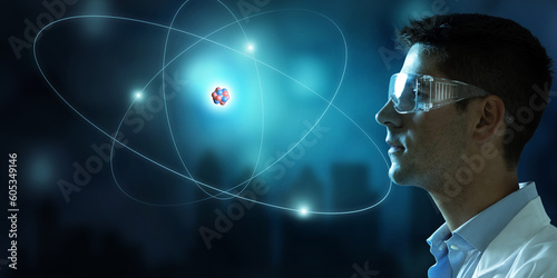 Tableau sur toile Scientist looking at virtual atom structure model with nucleus and glowing electrons
