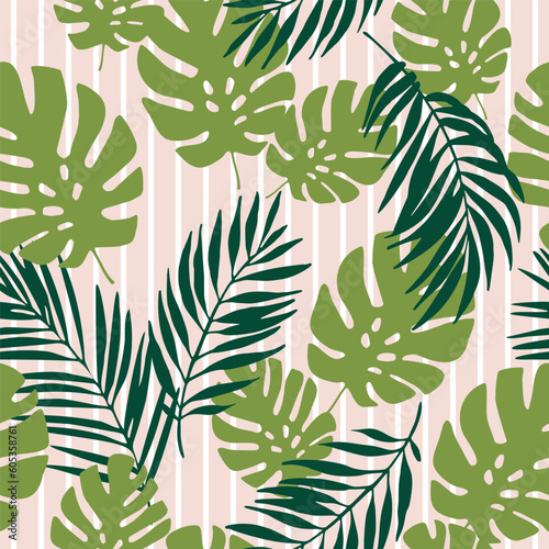Green tropical leaves on striped background. Seamless tropical pattern
