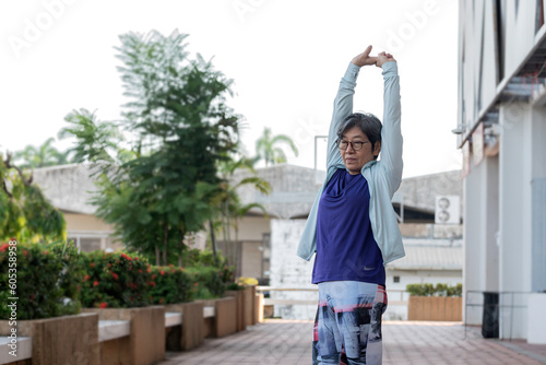 Asian senior women walk exercise outdoor in morning, feel relax and happy in holiday.