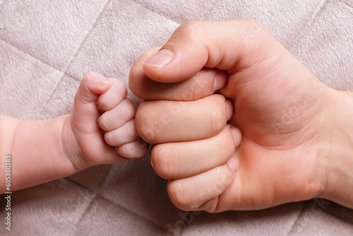Father's big fist and son's little hand collide with each other