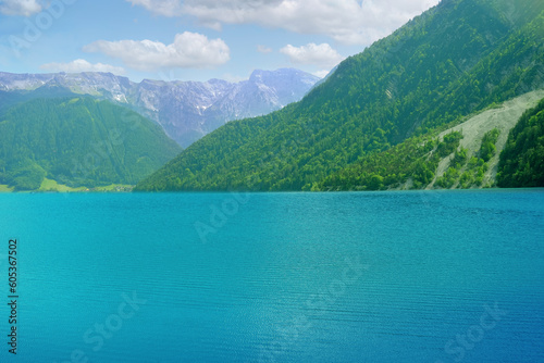 picturesque lake Achensee in Austria, green mountains rises above the calm expanse of water, the concept of the beauty of nature, vacation by the reservoir, water sports, resort place tyrol © kittyfly