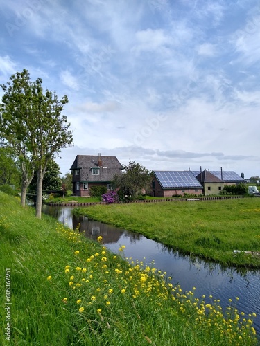 A cozy countryside house with solar panels at the water © Chanteur-de-Vent