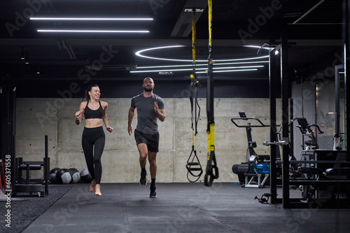 A fit couple in a modern gym, engaging in running exercises and showcasing their athletic prowess with a dynamic start.
