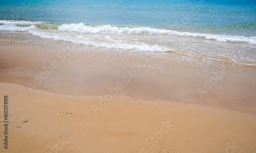 Wave on the sand beach background. Relaxing beach scene, summer vacation holiday template banner. Waves surf with amazing blue ocean lagoon, sea shore, coastline.