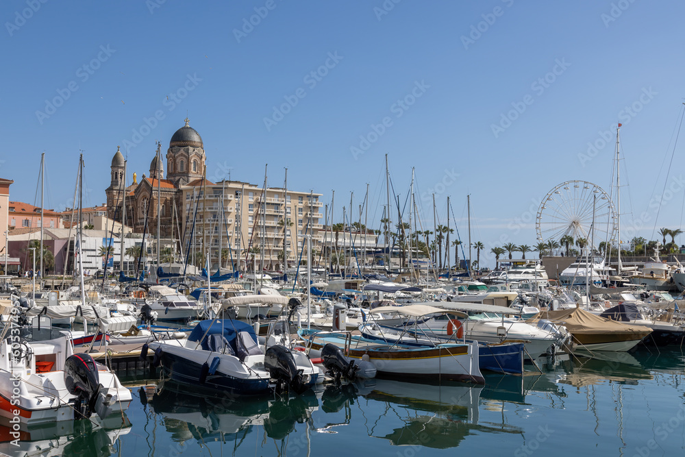 Saint Raphael looking across the harbor with yachts at Basilique Notre-Dame-de-la-Victoire in spring on the Cote d'Azur in France