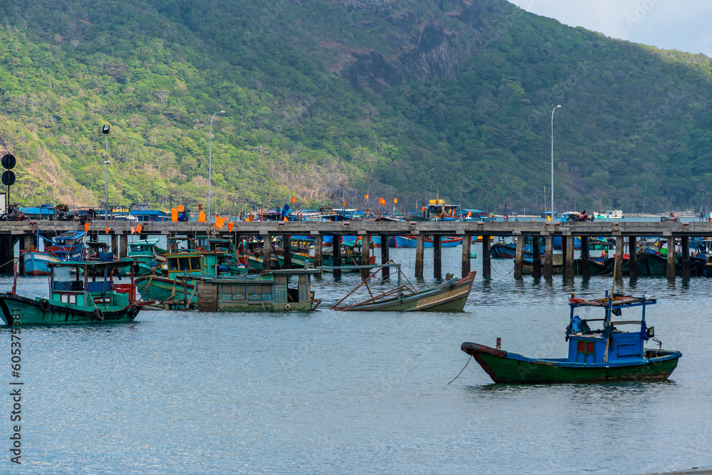 Ben Dam Port in Con Dao island, Vietnam with beautiful blue sea blue sky mountain and colorful boats.