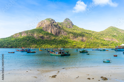 Ben Dam Port in Con Dao island, Vietnam with beautiful blue sea blue sky mountain and colorful boats.