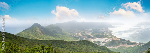 a peaceful Con Dao island  Vietnam  view from Thanh Gia mountain. Coastal view with waves  coastline  clear sky and road  blue sea and mountain.